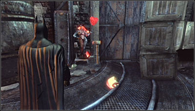 Stand in front of one of Harley heads (no matter whether its already destroyed or not) and scan it together with the hammer beside it (screen above) - Riddles | Steel Mill - Steel Mill - Batman: Arkham City Game Guide