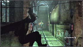 Stand in front of the electrified floor tiles, take out the Line Launcher and shoot it at the wall in the distance #1 - Enigma Conundrum (riddles 16-17) | Side missions - Side missions - Batman: Arkham City Game Guide