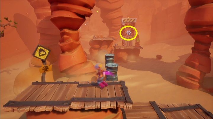 As you move on, you'll have to jump over the barrels and catch a point marked on the screen above with the hook - Crash 4: Truck Stopped walkthrough - The Hazardous Wasted, 2084 - Crash 4 Guide, Walkthrough