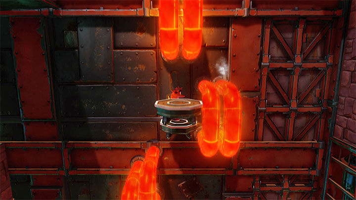 After reaching the small platform you start a new ride to the upper part of the screen during which you must, again, move from one moving platform to another before they get closer to hot pipes - Crash Bandicoot N. Sane Trilogy: Castle Machinery - Crash Bandicoot N. Sane Trilogy: Crash Bandicoot - Cortex Island - Crash Bandicoot N. Sane Trilogy Game Guide