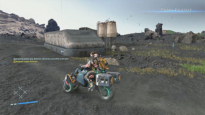 Look for a small building next to two tanks - God Particle Go-Getter trophy | Death Stranding - Trophy Guide - Death Stranding Guide