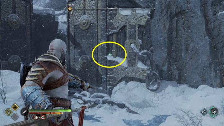 The bird is on a wall next to a large gate - God of War Ragnarok: Lake of Nine, Midgard - secrets, collectibles - God of War Ragnarok: Midgard - God of War Ragnarok Guide
