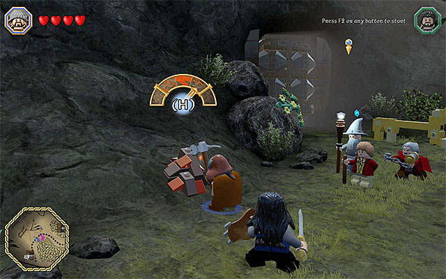 Destroying the heaps of bricks, with the pickaxe allows you to obtain ingots - Middle-Earth: Reach the troll cave | Walkthrough | LEGO The Hobbit - Walkthrough - LEGO The Hobbit Game Guide & Walkthrough