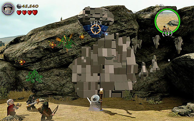 You need to aim the staff at the blue object above - Stage 5 (The Troll Hoard): The orc encounter | Walkthrough | LEGO The Hobbit - Walkthrough - LEGO The Hobbit Game Guide & Walkthrough