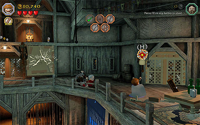 Keep using the slingshot on the target, until the gate is fully raised - Stage 12 (A Warm Welcome): The armory | Walkthrough | LEGO The Hobbit - Walkthrough - LEGO The Hobbit Game Guide & Walkthrough