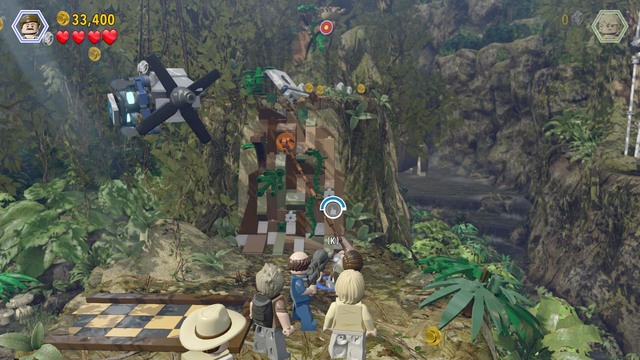 Climb up as Paul and use the rope on the catch shown in the screenshot and, as Billy, climb over the wall and take another parachute jump - Spinosaurus | Jurassic Park III - walkthrough - Jurassic Park III - walkthrough - LEGO Jurassic World Game Guide & Walkthrough