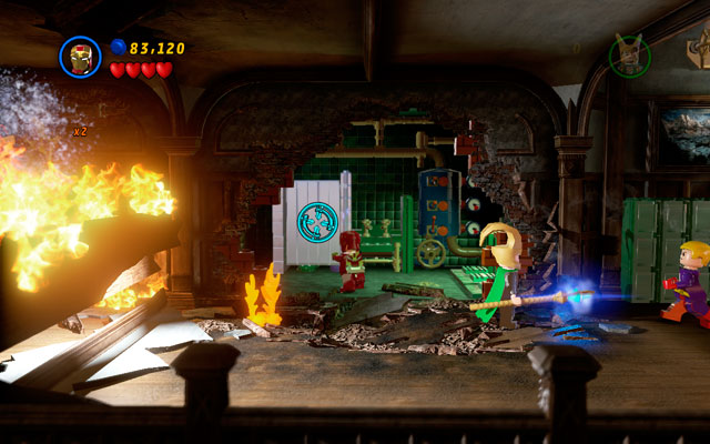 Head right and choose Iron Man to shoot your rockets at the silver toilet (in the bathroom behind the flames) - Juggernauts and Crosses | Minikit Sets - Minikit Sets - LEGO Marvel Super Heroes Game Guide & Walkthrough