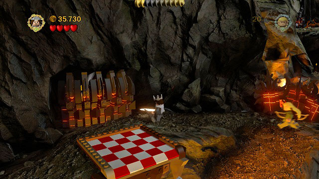 Drop the rock into the lava river, stand beside the tile and destroy the Morgul bricks there with Aragorn's sword - Prologue - Collectibles - LEGO The Lord of the Rings - Game Guide and Walkthrough
