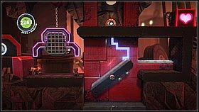 Upstairs, return to the left and jump onto the purple footbridge - from it you can reach an item - Bang for Buck - p. 1 - The Factory of a Better Tomorrow - LittleBigPlanet 2 - Game Guide and Walkthrough