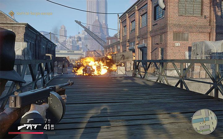 When you get closer to the bridge, you will have an excellent opportunity to hit barrels and blow up vehicles - Mafia Definitive Edition: You Lucky Bastard - walkthrough - Walkthrough - Mafia Definitive Edition Guide, Walkthrough