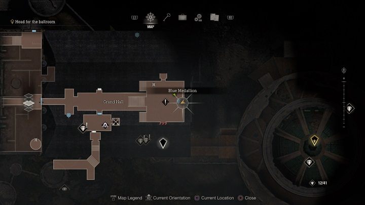 The second medallion is hanging beneath the ceiling on a lower floor, at the east end of the Great Hall - Resident Evil 4 Remake: Destroy the Blue Medallions 4 - Blue Medallions - Resident Evil 4 Remake Guide