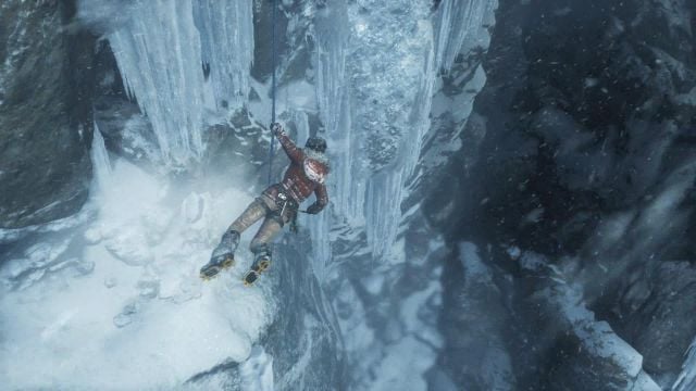 Lara is hanging on the rope - Rise of the Tomb Raider: Get to the top of the mountain walkthrough - Siberian Wilderness - Passageway - Rise of the Tomb Raider Guide