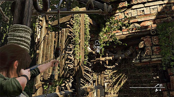Stand next to the wooden structure and shoot the rope coil shown above - How to complete the Trial of the Eagle in Shadow of the Tomb Raider Game? - Solving Riddles - Shadow of the Tomb Raider Game Guide