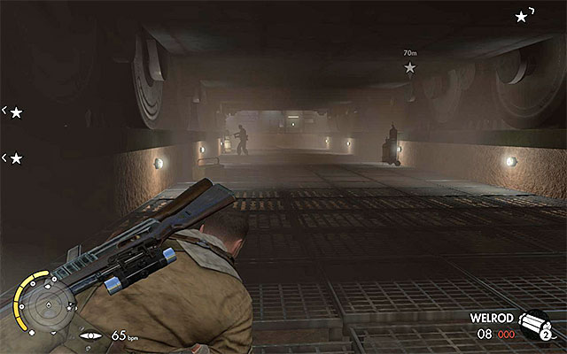 You can find the enemies both under the tank and behind it - Sniper Elite 3 Afrika: Exploring the tank hall - Sniper Elite 3 Afrika: Mission 8 - Ratte Factory - Sniper Elite III: Afrika Game Guide