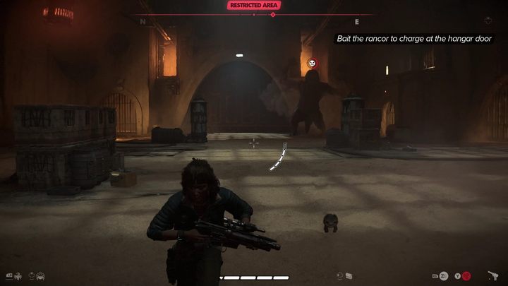 Getting hit by the explosion will provoke the rancor into a charge - you will recognize this by the red indicator above its head - Star Wars Outlaws: How to defeat the rancor? - Quests and data - Star Wars Outlaws Guide