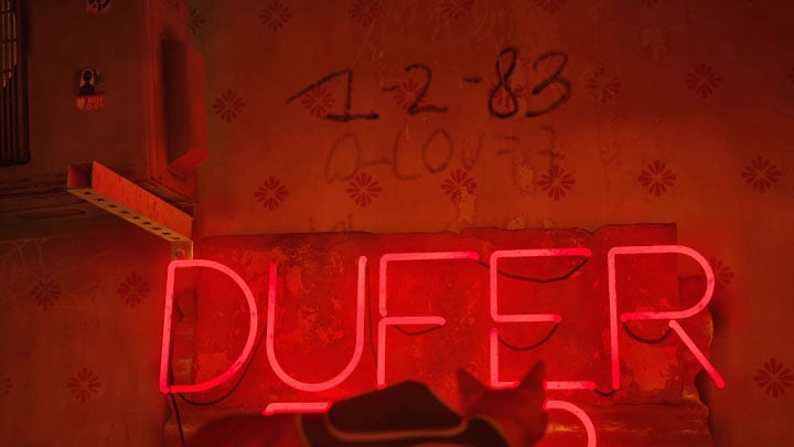 In the bar, jump on the counter and examine the left picture hanging on the wall - Stray: The puzzle with the safe and the note with the binary code - The Slums - Puzzles - Stray Guide, Walkthrough