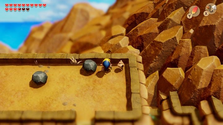 You will find a Secret Seashell under one of the stones - Turtle Rock | Links Awakening Walkthrough - Walkthrough - Links Awakening Guide