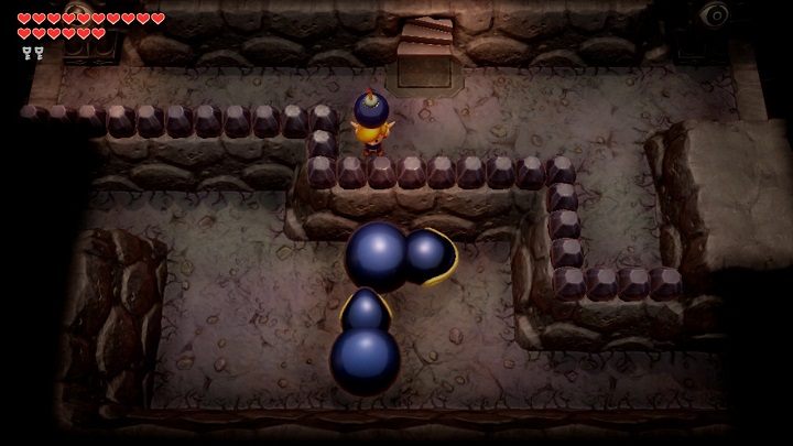 Standing at the railing, drop the bombs directly into the mouth of Dodongo snakes - Turtle Rock | Links Awakening Walkthrough - Walkthrough - Links Awakening Guide