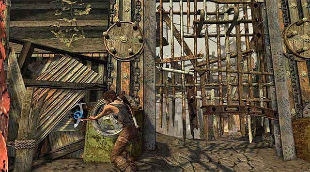 Approach the left gate mechanism and use the climbing axe (tap the action button) to unlock access to the southern area of the town, and a new base camp (Ancient Gate) (reward: 100 XP) - Reach the Gate Under the Bridge | 14: Highway to Hell Walkthrough - 14: Highway to Hell | Walkthrough - Tomb Raider Game Guide