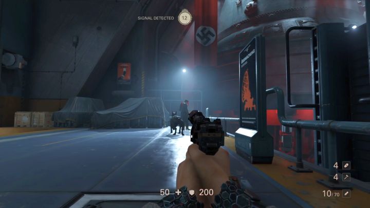 The second Commander is accompanied by a dog, the animal can detect you easily. - Elevator and Hangar | Chapter 4 - Roswell | Walkthrough - Chapter 4 - Roswell - Wolfenstein II: The New Colossus Game Guide